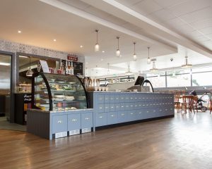 Interior of The Kitchen cafe at Grange Leisure Park near Mablethorpe, Lincolnshire, designed by Norfolk architects Paul Robinson Partnership. Features include a modern counter, display area, and seating for visitors