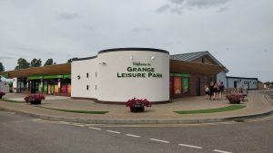 Grange Leisure Park facilities building near Mablethorpe, Lincolnshire, designed by Norfolk architects Paul Robinson Partnership. The modern structure serves as a landmark holiday centre surrounded by landscaped open countryside, offering a wide range of activities and amenities