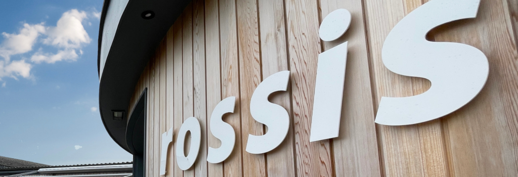 Rossi Leisure stand off signs on timber cladding